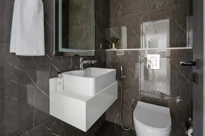 a bathroom with a white sink and a toilet at Frank Porter - Samana Park Views in Dubai
