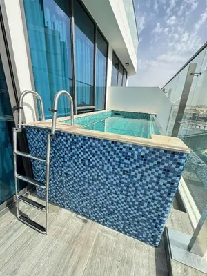 a swimming pool on the balcony of a building at Frank Porter - Samana Park Views in Dubai