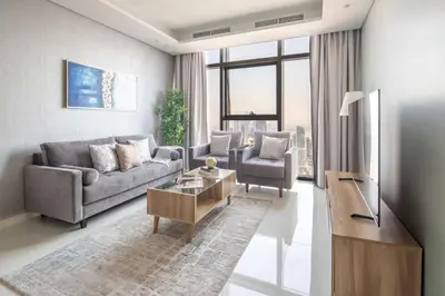 a living room with a couch and a table at Frank Porter - Paramount Midtown in Dubai