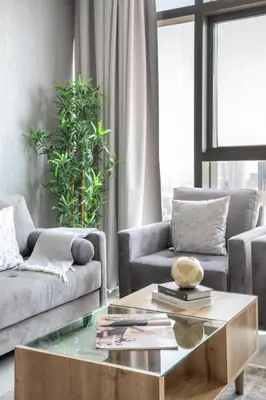 a living room with two couches and a coffee table at Frank Porter - Paramount Midtown in Dubai