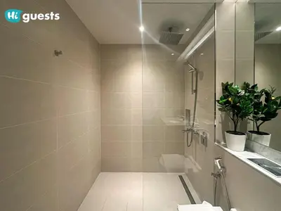 a bathroom with a shower and a toilet and a sink at HiGuests - Elegant 1BR Retreat with Sea View in La Rive in Dubai