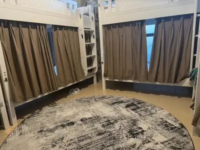 a room with a rug on the floor and windows at Best view homes in Dubai