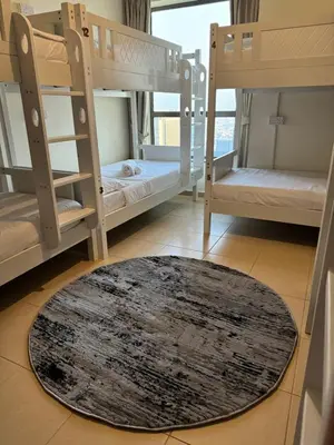 a room with bunk beds and a rug on the floor at Best view homes in Dubai