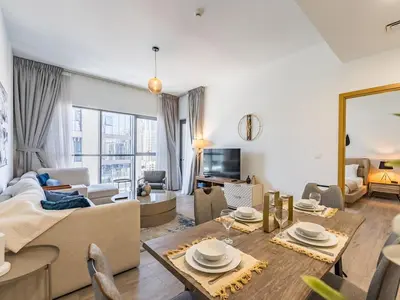 a living room with a couch and a table at Modern Retreat with Balcony and Burj Khalifa View in Dubai