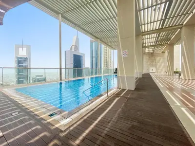 a swimming pool in a building with a view of the city at Silkhaus Comfy Studio in Liberty House DIFC Heart in Dubai