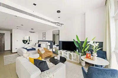 a living room with a couch and a table at Silkhaus Comfy Studio in Liberty House DIFC Heart in Dubai