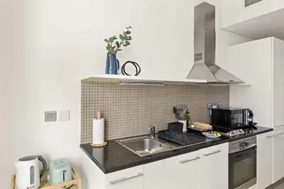 a kitchen with a sink and a microwave at Silkhaus Comfy Studio in Liberty House DIFC Heart in Dubai