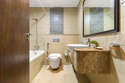 a bathroom with a sink and a toilet and a tub at Silkhaus Comfy Studio in Liberty House DIFC Heart in Dubai