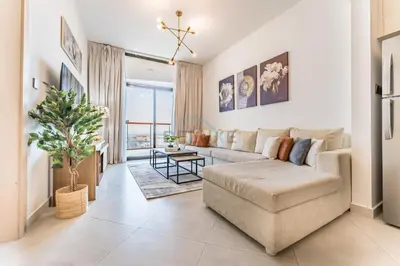 a living room with a couch and a table at Community View 1BR with Balcony Near Downtown Dubai, Binghatti Avenue, Al Jaddaf by Deluxe Holiday Homes in Dubai
