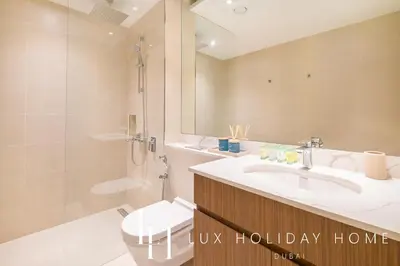 a bathroom with a sink and a toilet and a shower at LUX The La Mer Luxury Burj View Suite 3 in Dubai