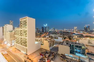 an aerial view of a city at night at City Views 1BR with Private Balcony, Binghatti House, Jumeirah Village Circle by Deluxe Holiday Homes in Dubai
