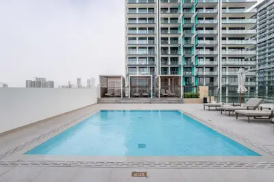 a swimming pool on the roof of a building at City Views 1BR with Private Balcony, Binghatti House, Jumeirah Village Circle by Deluxe Holiday Homes in Dubai