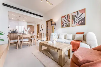 a living room with a couch and a table at City Views 1BR with Private Balcony, Binghatti House, Jumeirah Village Circle by Deluxe Holiday Homes in Dubai