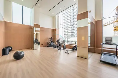 a gym with treadmills and exercise equipment in a building at City Views 1BR with Private Balcony, Binghatti House, Jumeirah Village Circle by Deluxe Holiday Homes in Dubai