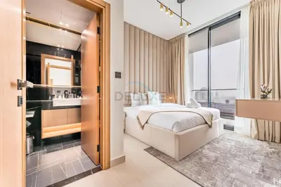 a bedroom with a bed and a bathroom with a sink at City Views 1BR with Private Balcony, Binghatti House, Jumeirah Village Circle by Deluxe Holiday Homes in Dubai
