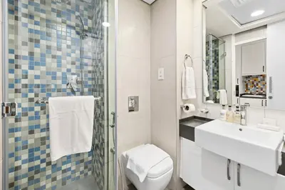 a bathroom with a toilet and a sink and a mirror at Studio Palm Views West, Palm Jumeirah in Dubai
