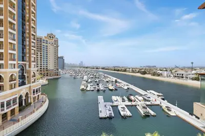 a marina with boats in the water next to buildings at Studio Palm Views West, Palm Jumeirah in Dubai