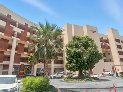 a building with two palm trees in front of it at Studio Palm Views West, Palm Jumeirah in Dubai