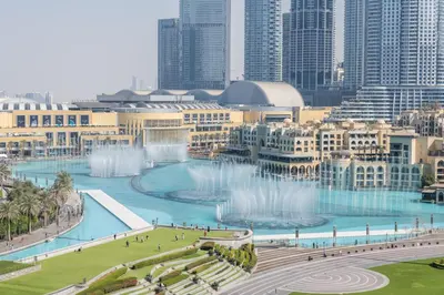 a view of a city with fountains and buildings at Hermes-Style 2BR, Full Burj Khalifa View - Infinity Pool - Full Fountain View in Dubai