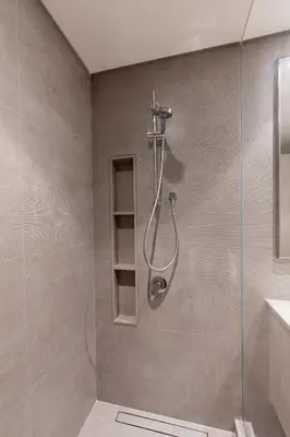 a shower with a glass door in a bathroom at Hermes-Style 2BR, Full Burj Khalifa View - Infinity Pool - Full Fountain View in Dubai