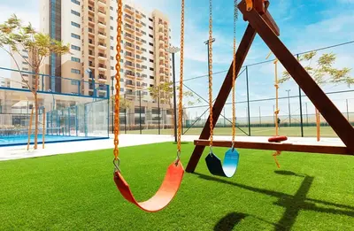 a swing in a playground in a building at Pure Voyage Town Square in Dubai