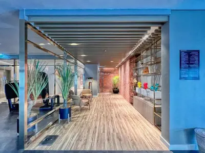 an office with a hallway with chairs and plants at The Highest Infinity Pool in Downtown Dubai in Dubai