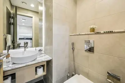 a bathroom with a sink and a mirror at The Highest Infinity Pool in Downtown Dubai in Dubai