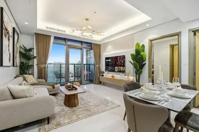 a living room with a couch and a table and chairs at The Highest Infinity Pool in Downtown Dubai in Dubai