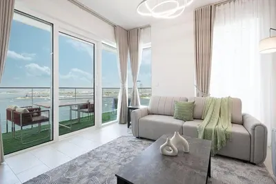 a living room with a couch and a view of the ocean at La Vie in JBR! Private Beach! Excellent Apartments! in Dubai