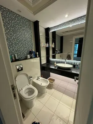 a bathroom with a toilet and a sink at Bright and Airy 2BR Bay Retreat in Dubai