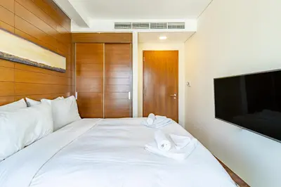 a bedroom with a white bed with towels on it at SuperHost EMAAR Residences - Former Address Dubai Mall in Dubai