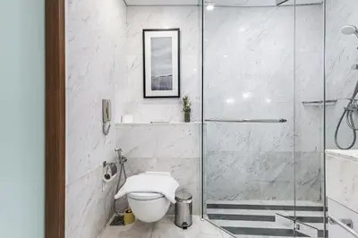 a bathroom with a glass shower and a toilet at SuperHost EMAAR Residences - Former Address Dubai Mall in Dubai
