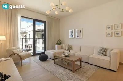 a living room with a couch and a table at HiGuest - Stylish 1BR Apartment in La Mer in Dubai