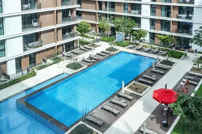 an overhead view of a swimming pool in a building at Premium Home in Park Point Near Dubai Hills Mall in Dubai