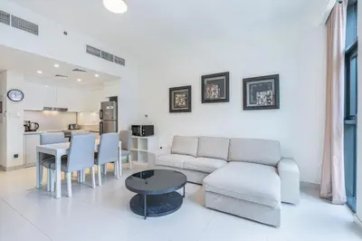 a living room with a couch and a table at Premium Home in Park Point Near Dubai Hills Mall in Dubai