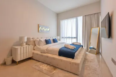 a bedroom with a large bed and a large window at Downtown Luxury 2BR - Full Burj Khalifa & Fountain Views - 5 Minutes Walk to Dubai Mall in Dubai