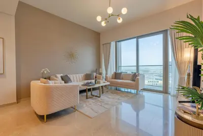 a living room with a couch and a table at Downtown Luxury 2BR - Full Burj Khalifa & Fountain Views - 5 Minutes Walk to Dubai Mall in Dubai