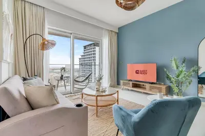 a living room with a couch and a tv at GuestReady - Amazing home with a Great sea view in Dubai