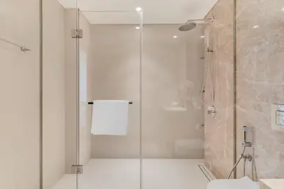 a bathroom with a glass shower and a toilet at GuestReady - Amazing home with a Great sea view in Dubai