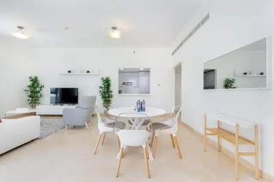 a dining room with a table and chairs at Stylish 1-Bedroom with Stunning Marina Views at Dorra Bay in Dubai