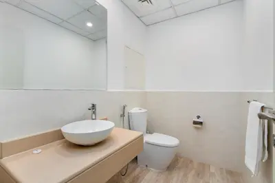 a bathroom with a bowl sink and a toilet at Spacious 1-Bedroom at the Heart of JBR in Dubai