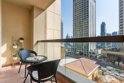 a balcony with a table and chairs and a view of a city at Spacious 1-Bedroom at the Heart of JBR in Dubai