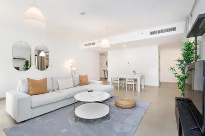 a living room with a white couch and a table at Spacious 1-Bedroom at the Heart of JBR in Dubai