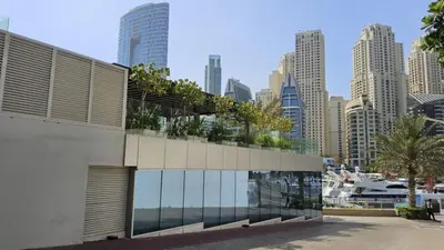 a building with trees on top of it in a city at Condor Marina Star Seaview Studio, Dubai Marina in Dubai