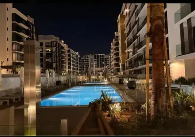 a large swimming pool in the middle of a building at AMLY holiday home DUBAI in Dubai
