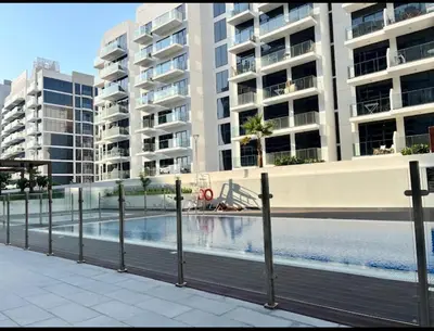 a swimming pool in front of some apartment buildings at AMLY holiday home DUBAI in Dubai
