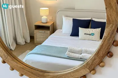 a bedroom with a bed with a large mirror at HiGuest - Elegant 1BR Oasis in La Mer in Dubai
