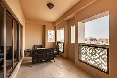 a living room with a window and a table and chairs at Balqis I Renovated 3BDR with 1 maid room I Palm Jumeirah in Dubai