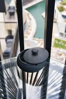 a black hat sitting on top of a glass table at Classic BNB - Ahad Large 1BR for 4 in Dubai