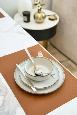 a table with two plates and silverware on it at Classic BNB - Ahad Large 1BR for 4 in Dubai
